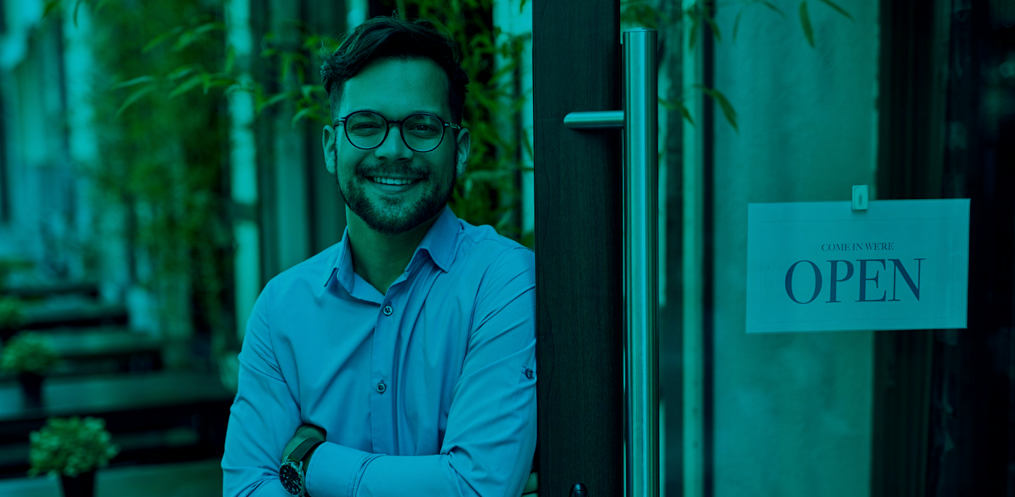 business owner stand beside his business shop door, Open Sign on the door