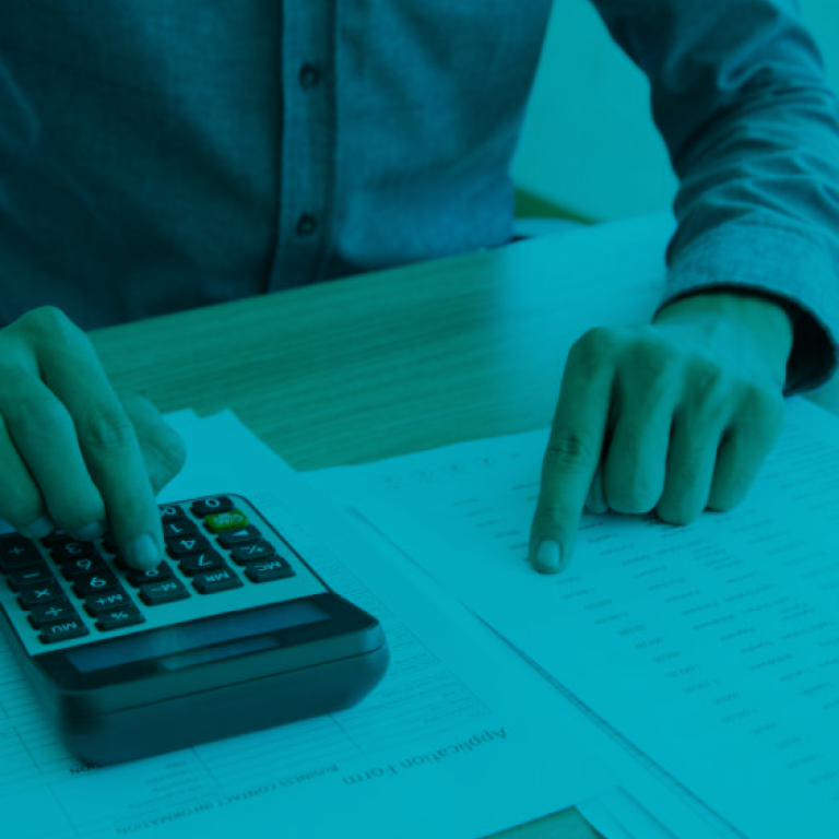 man counting in the calculator all the bills